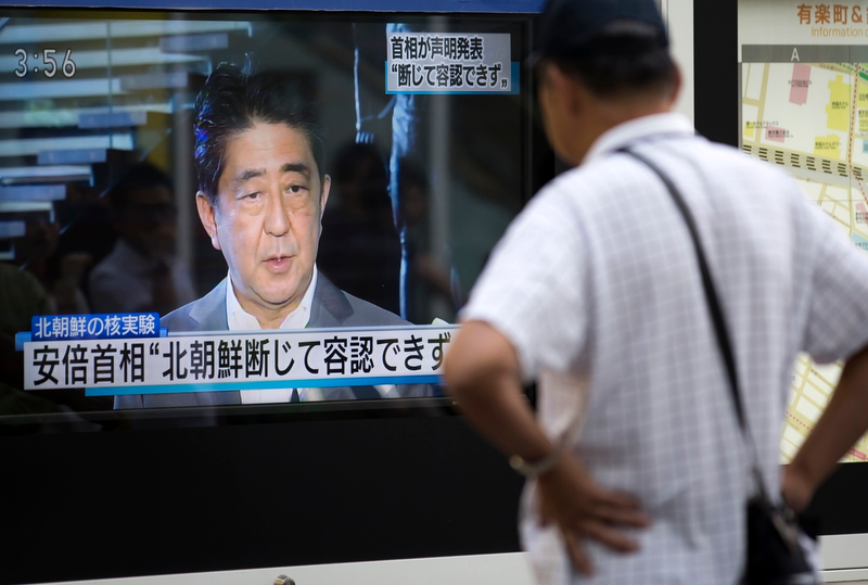 A pedestrian watches a monitor showing an image of Japanese Prime Minister Shinzo Abe in a news program reporting on North Korea’s 6th nuclear test on September 3, 2017 in Tokyo, Japan. (Photo by Tomohiro Ohsumi/Getty Images)
